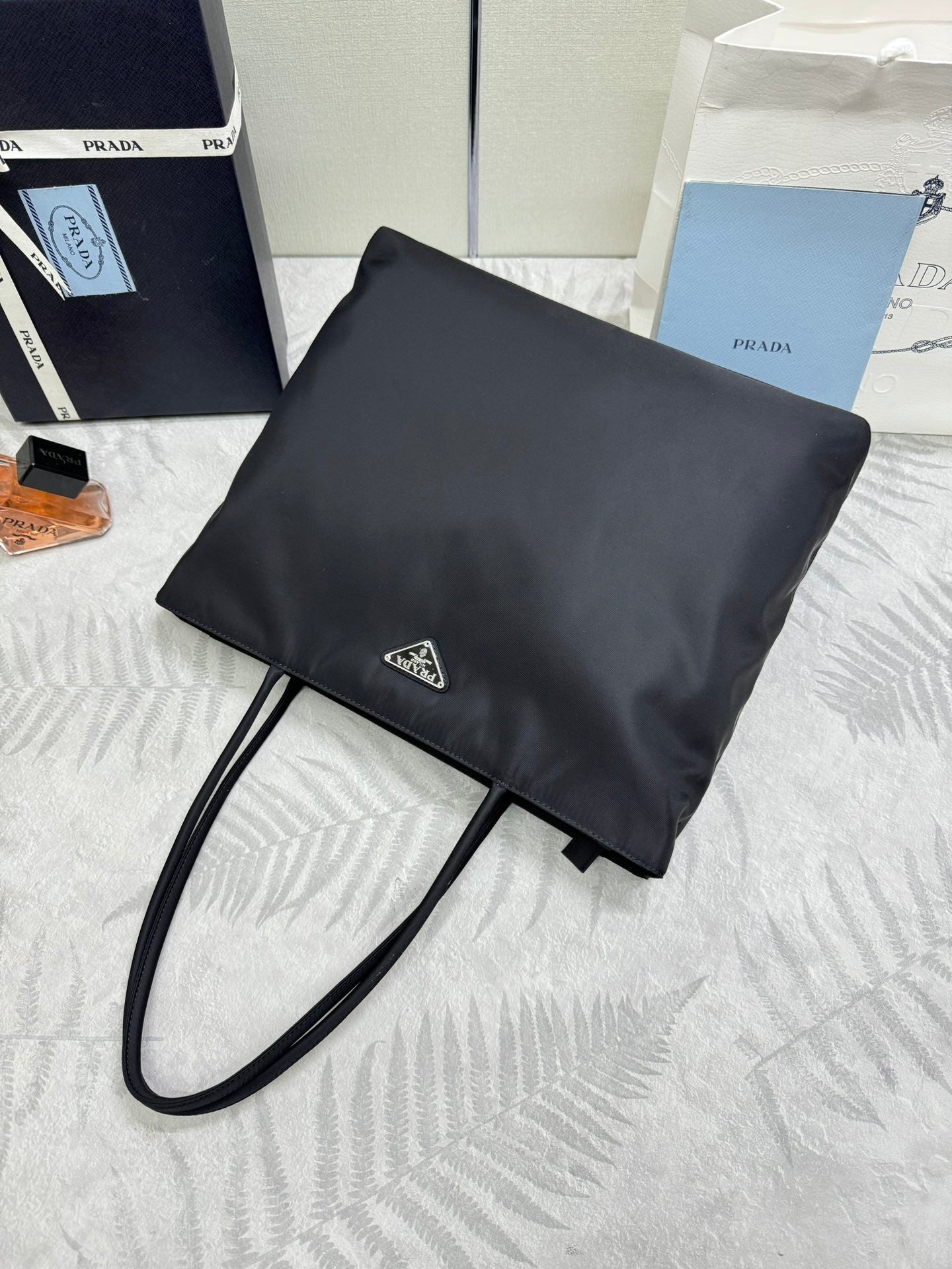 Prada pouch bag in dark fabric with strap and triangular logo patch