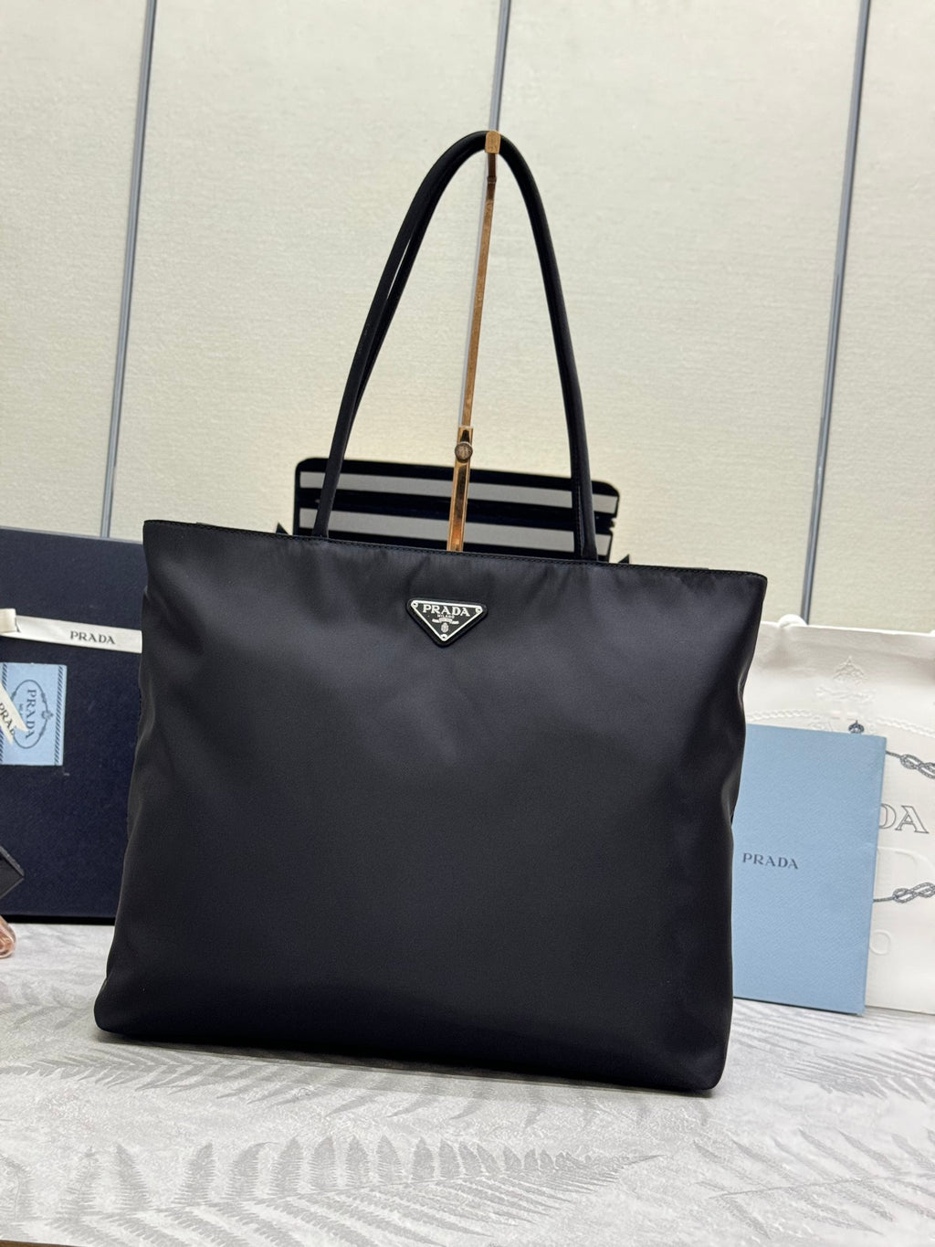 Prada tote bag in dark fabric with triangular logo at center front