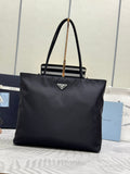 Prada tote bag in dark fabric with triangular logo at center front