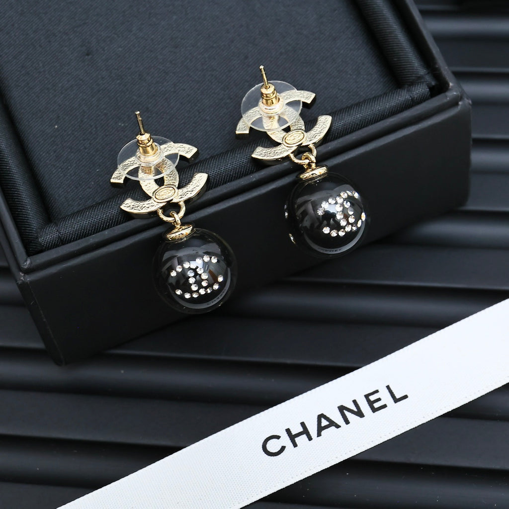 Chanel drop earrings with CC designs, gold posts, and black sphere beads
