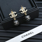 Chanel drop earrings with CC designs, gold posts, and black sphere beads