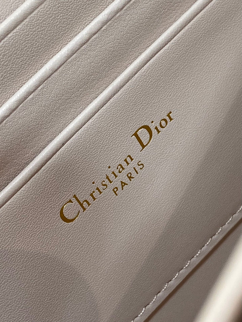 Christian Dior Paris embossed on pale pink inner lining with stitching