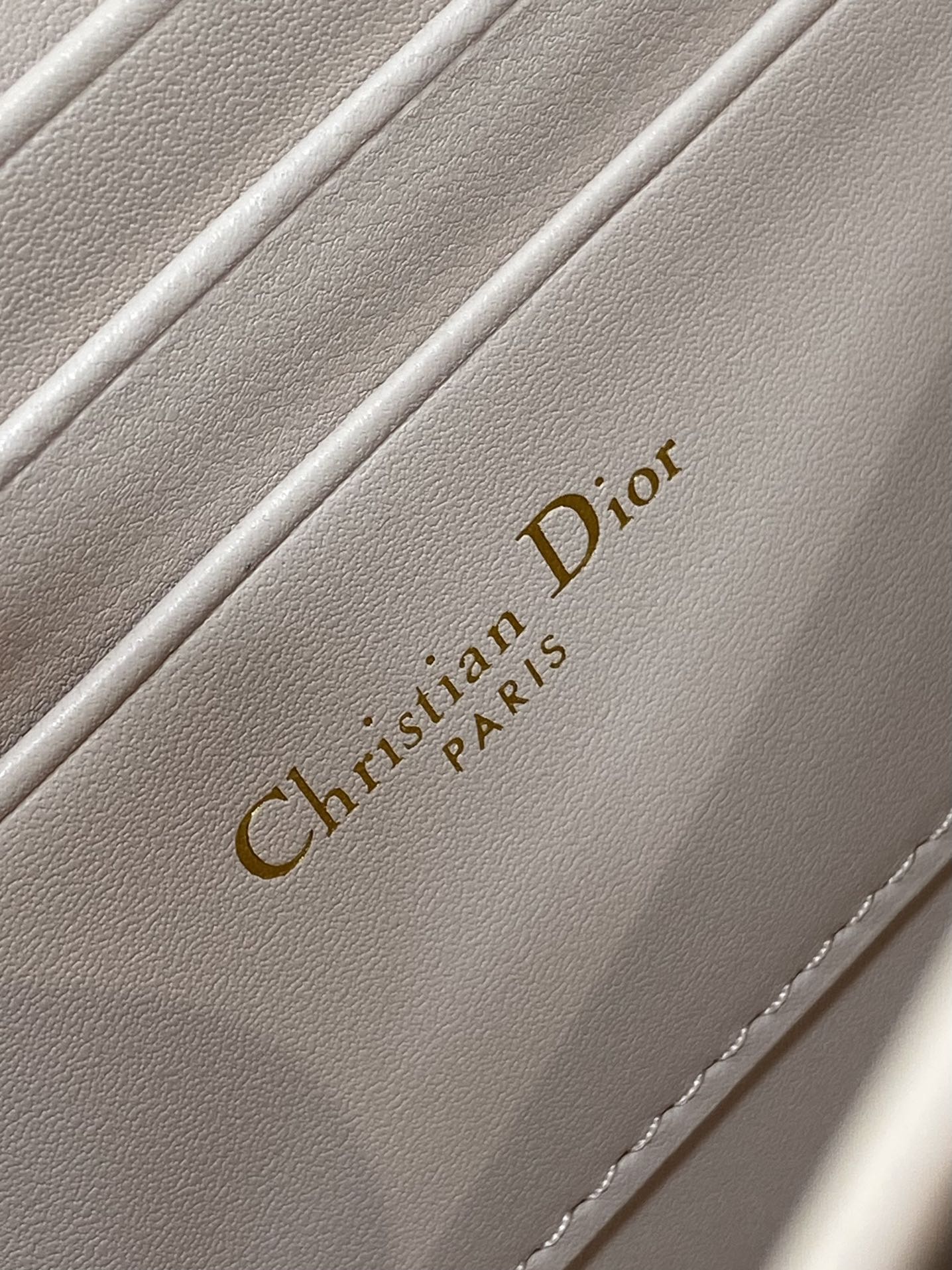 Christian Dior Paris embossed on pale pink inner lining with stitching