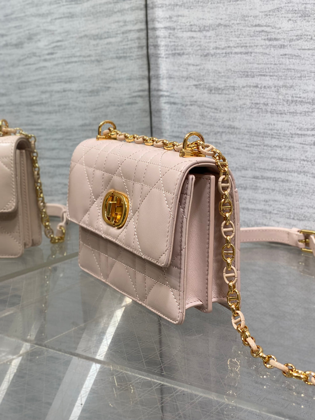 Dior pale pink quilted shoulder bag side view with gold chain hardware