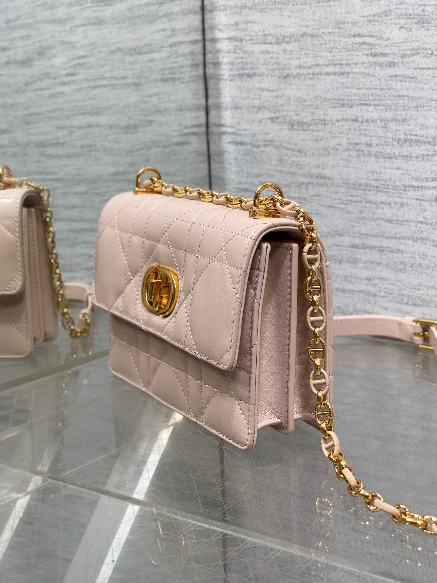 Dior pale pink quilted shoulder bag side view with gold chain hardware