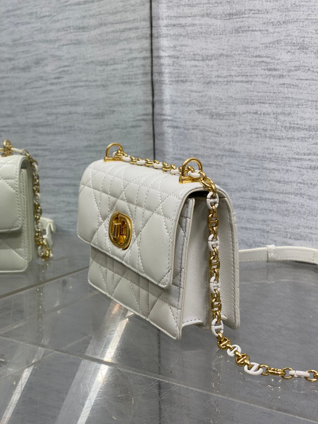 Dior handbag angled side view with gold chain and white leather flap