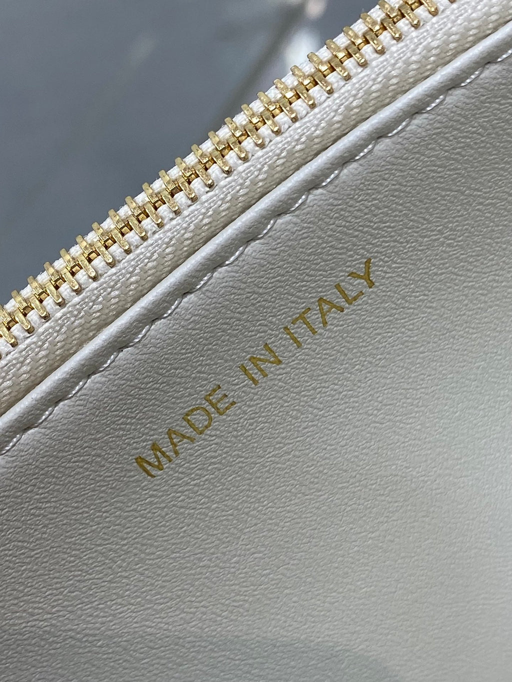 Dior handbag interior label with 'Made in Italy' on white leather