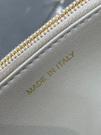 Dior handbag interior label with 'Made in Italy' on white leather