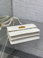 Dior handbag top view with white quilted leather and gold logo clasp