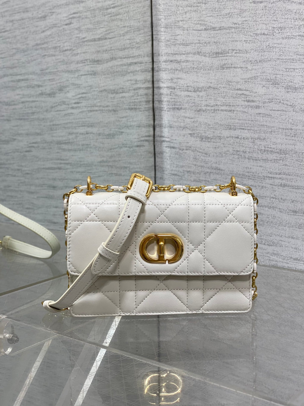 Dior handbag with quilted white finish, gold CD clasp, and shoulder chain strap