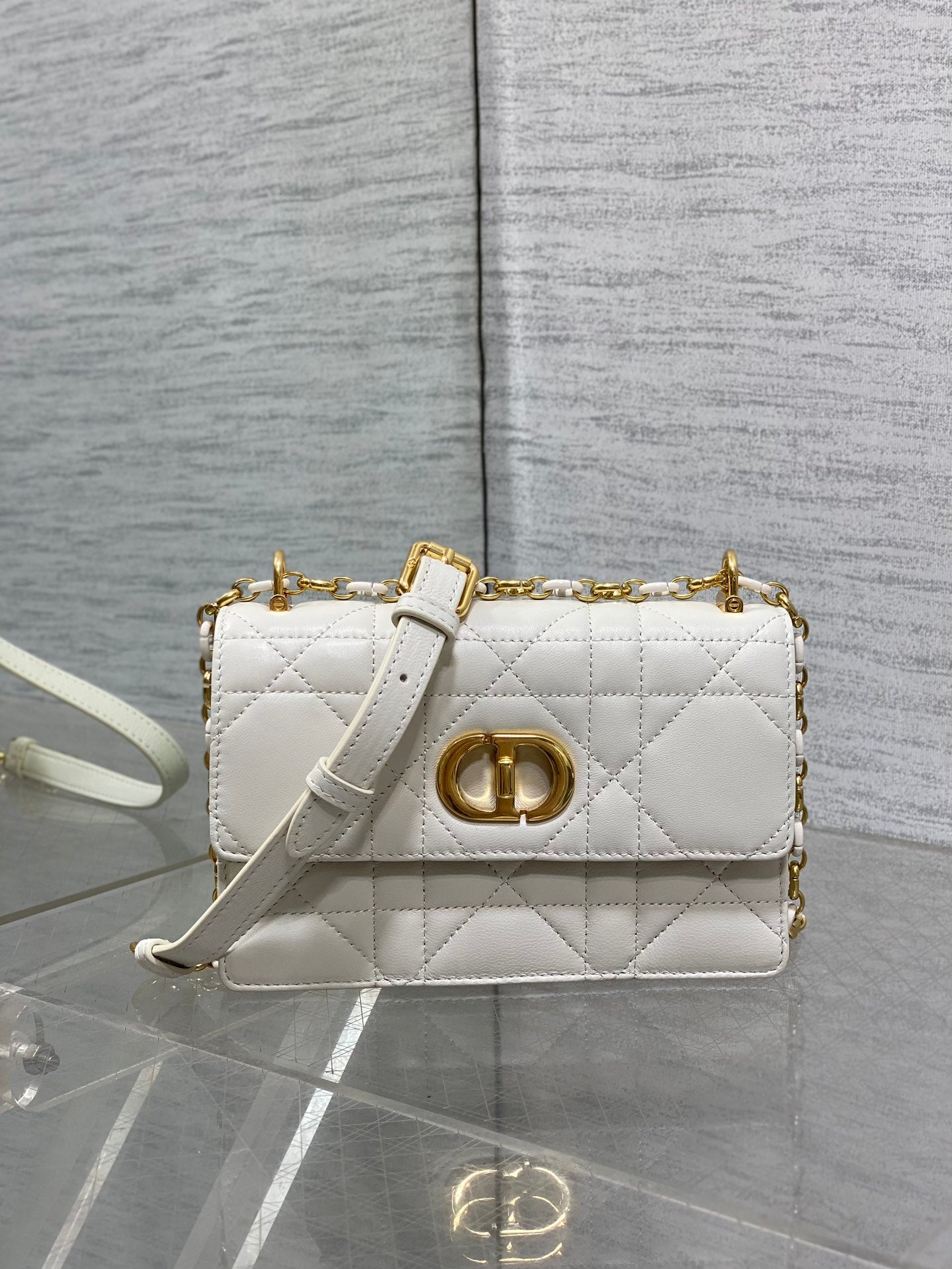 Dior handbag with quilted white finish, gold CD clasp, and shoulder chain strap