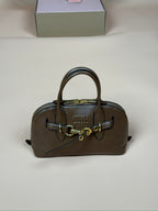 Miu Miu top-handle handbag in brown with gold hardware and structured sides