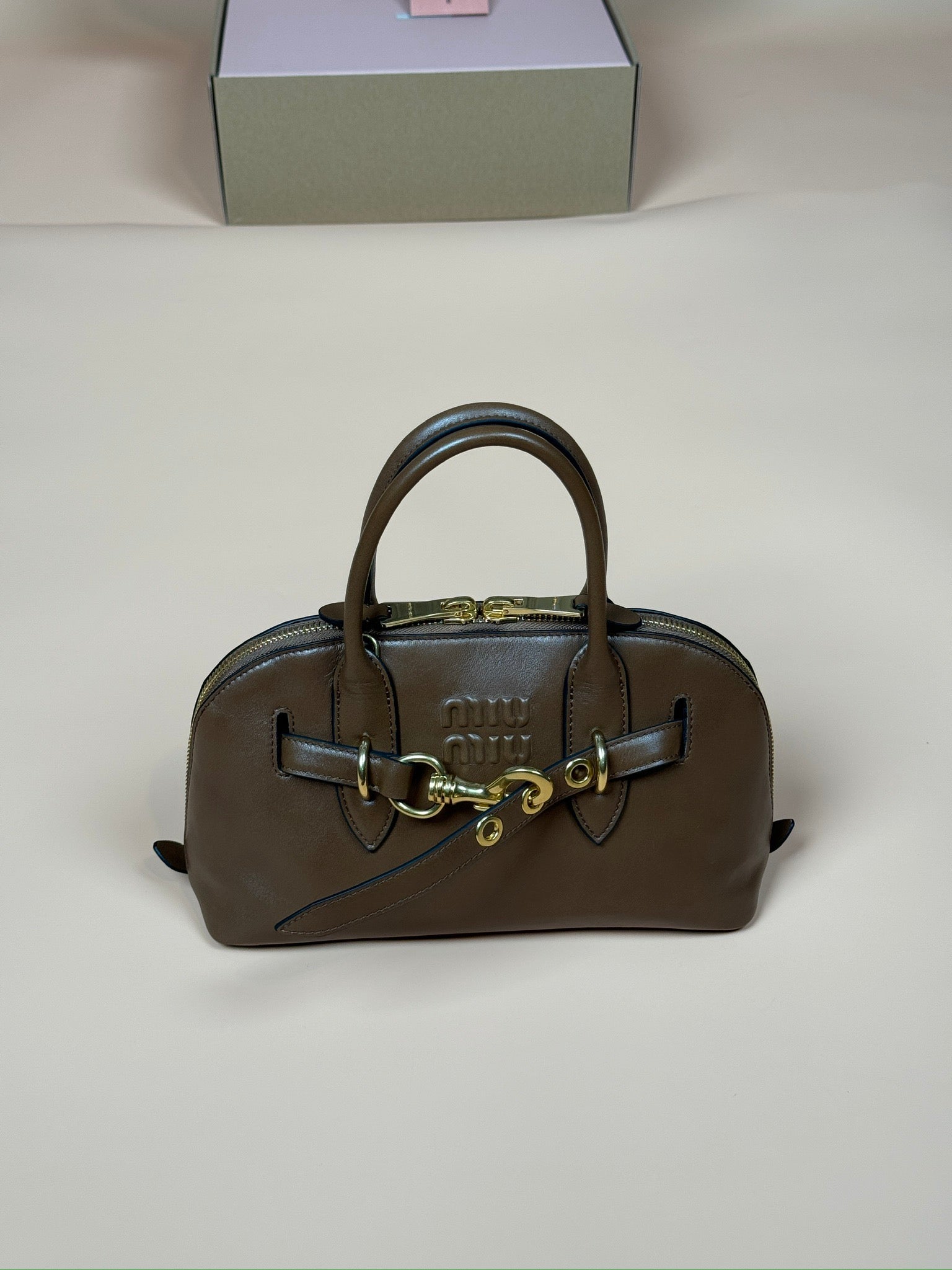 Miu Miu top-handle handbag in brown with gold hardware and structured sides