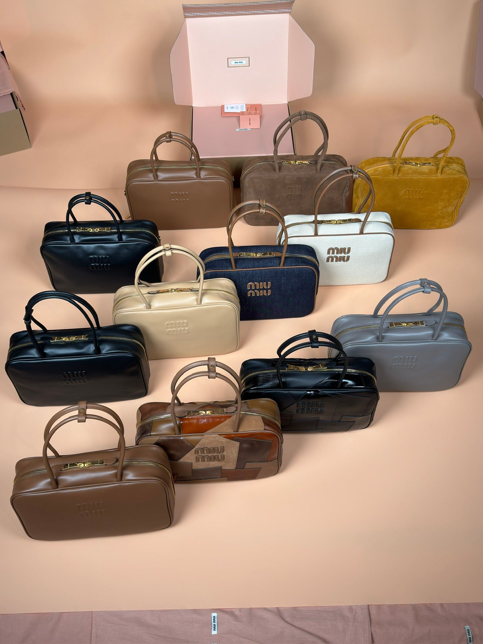 Assorted Miu Miu handbags, various sizes and colors, top-handle styles