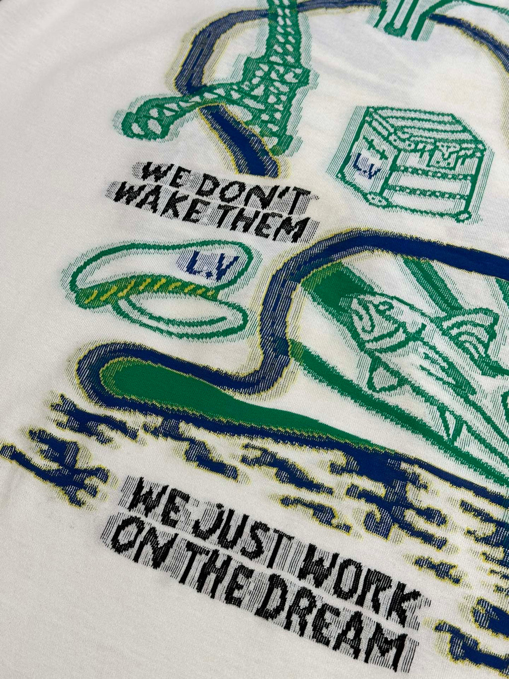White T-shirt chest print with green-and-blue illustrations and slogan text