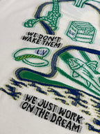 White T-shirt chest print with green-and-blue illustrations and slogan text