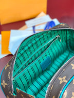 Brown monogram pouch with teal striped lining and silver zipper