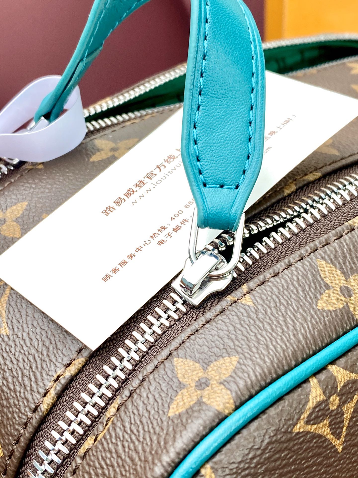 Teal leather zipper pull and ring on monogram pouch