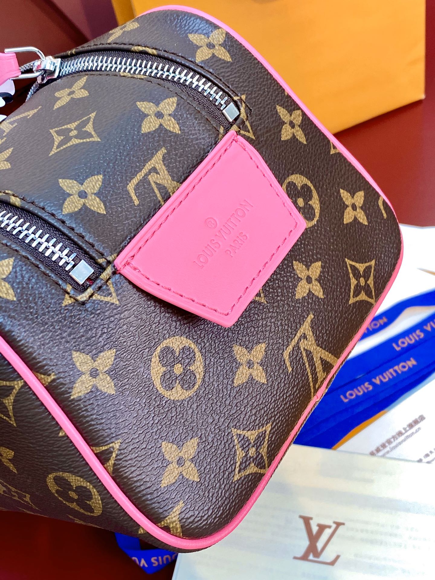 Louis Vuitton monogram toiletry bag side view with pink leather patch