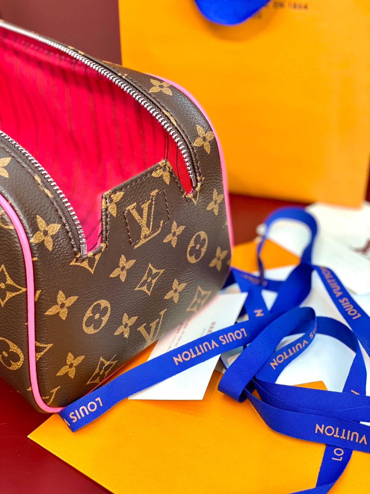Louis Vuitton monogram toiletry bag with pink accent seam and zipper edge
