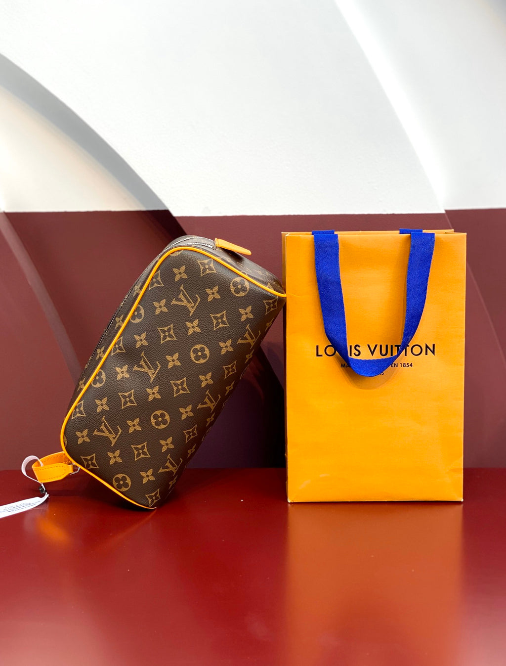 Louis Vuitton monogram toiletry bag with yellow trim and zip closure
