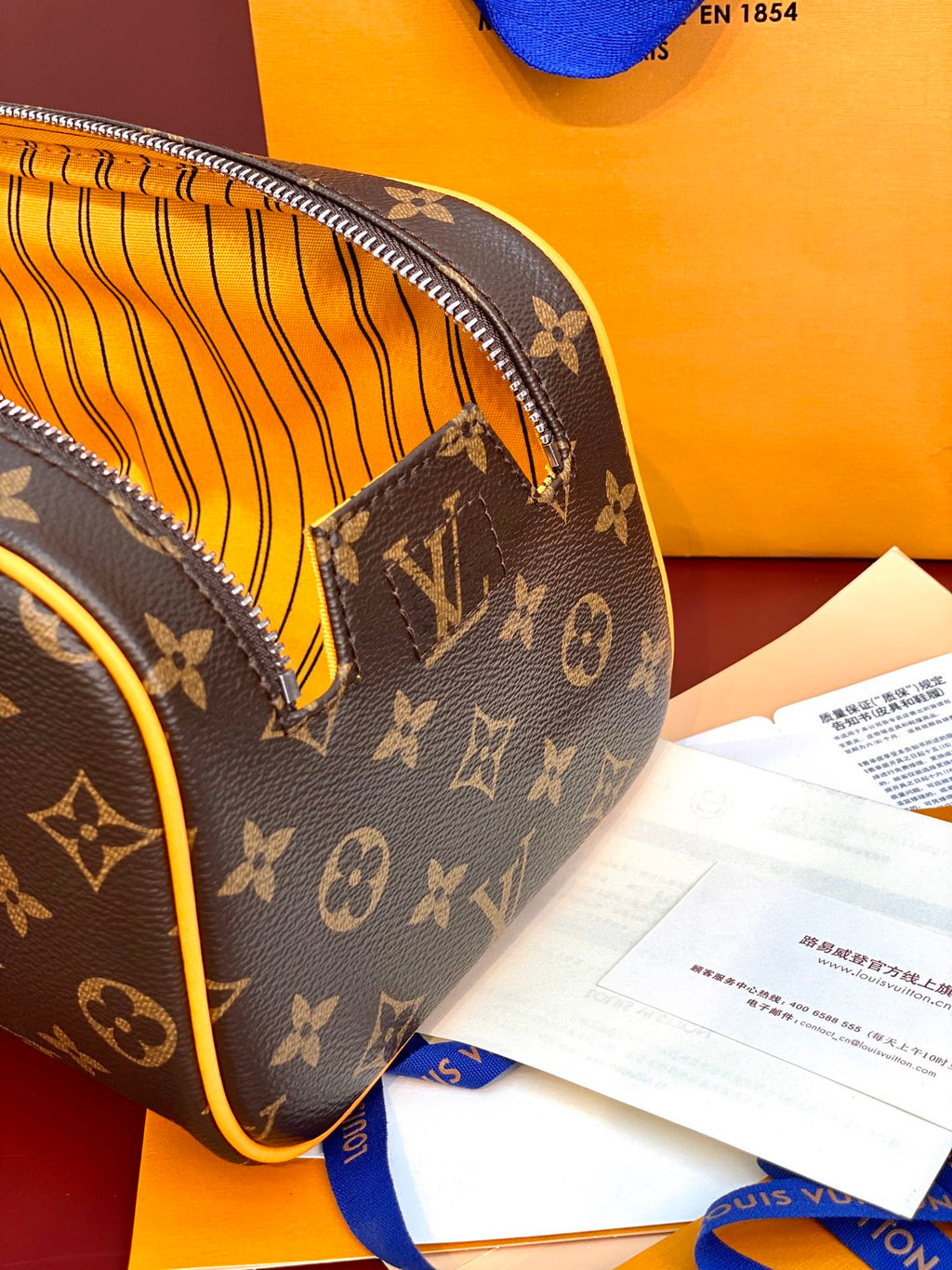 Louis Vuitton monogram toiletry bag corner with yellow striped interior lining