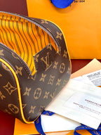 Louis Vuitton monogram toiletry bag corner with yellow striped interior lining