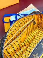 Louis Vuitton toiletry bag with striped yellow lining and zippered interior