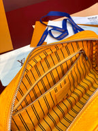 Yellow Louis Vuitton pouch bag interior with monogram lining and zipper edge.