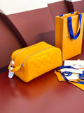 Yellow Louis Vuitton pouch bag with embossed monogram texture and zip closure.