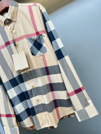 Burberry plaid button-up shirt with pocket detail and long sleeves, gold button front