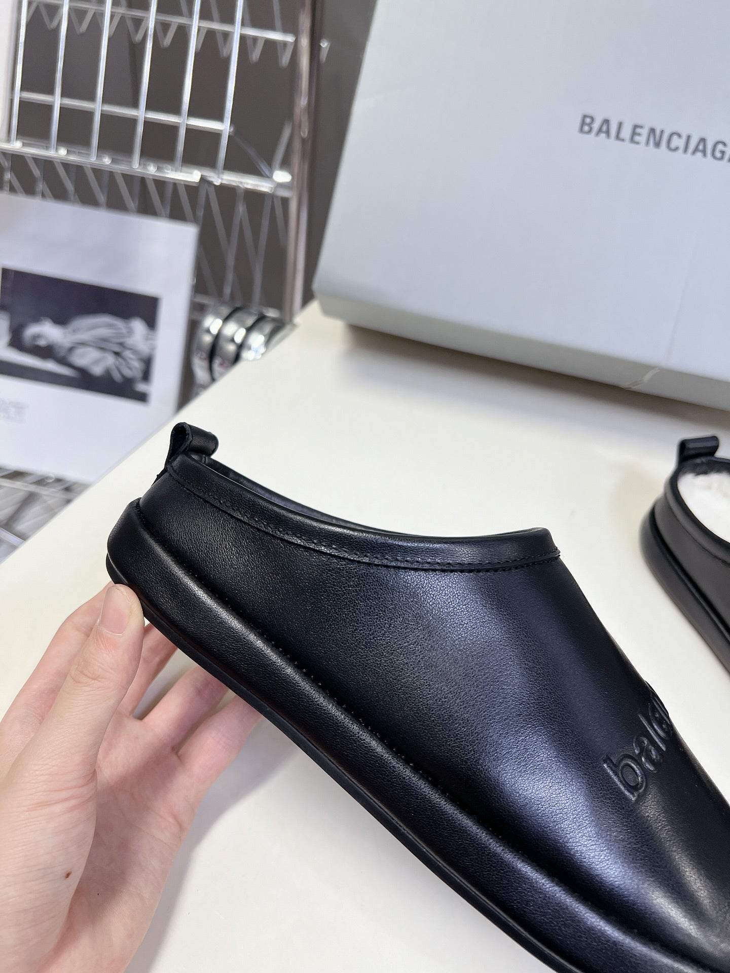 Black leather slide sandals with low vamp and heel strap