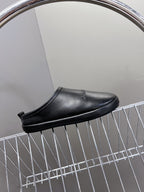 Black leather clog-style slide sandals with open heel