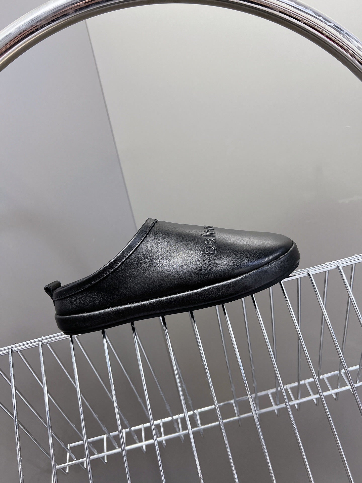 Black leather clog-style slide sandals with open heel