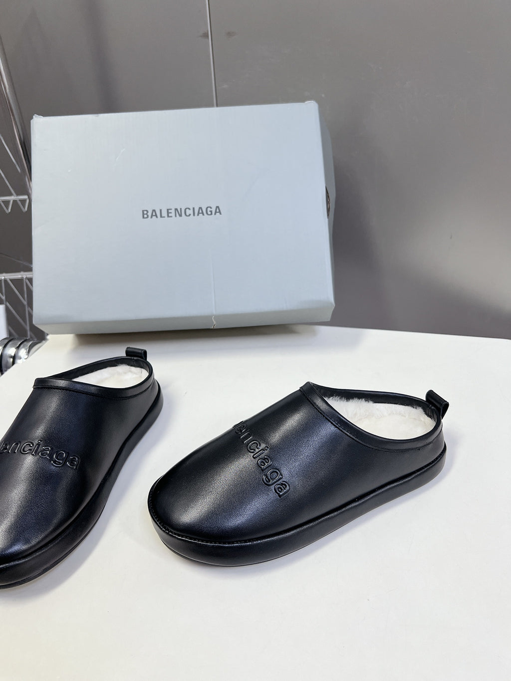 Black leather slide sandals with curved toe and open heel