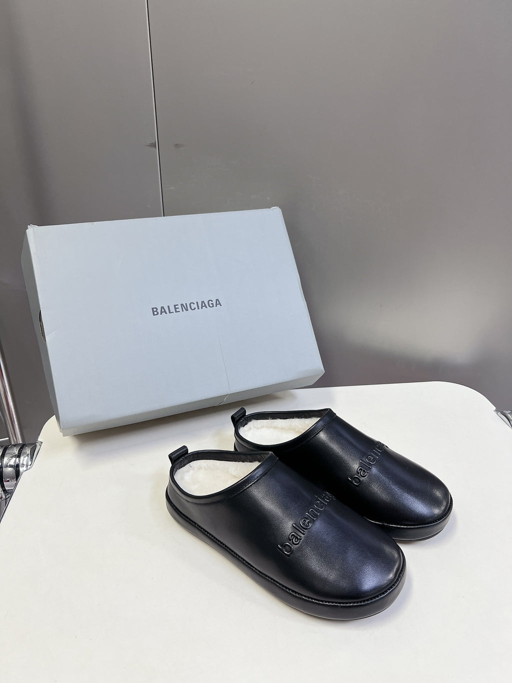 Black leather slide sandals with open back and sling strap
