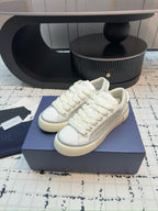 Dior unisex lace-up sneakers, white leather, close-up of lace panel
