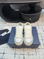 Dior unisex lace-up sneakers, white leather, front view pair