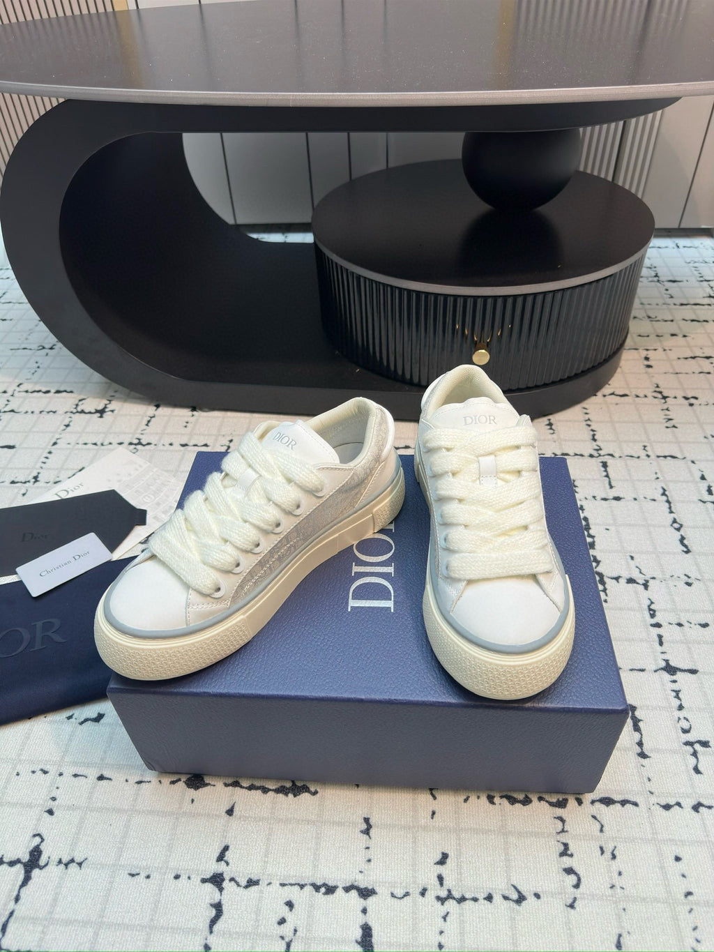 Dior unisex lace-up sneakers, white leather, three-quarter view with DIOR side