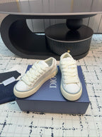 Dior unisex lace-up sneakers, white leather, three-quarter view with DIOR side