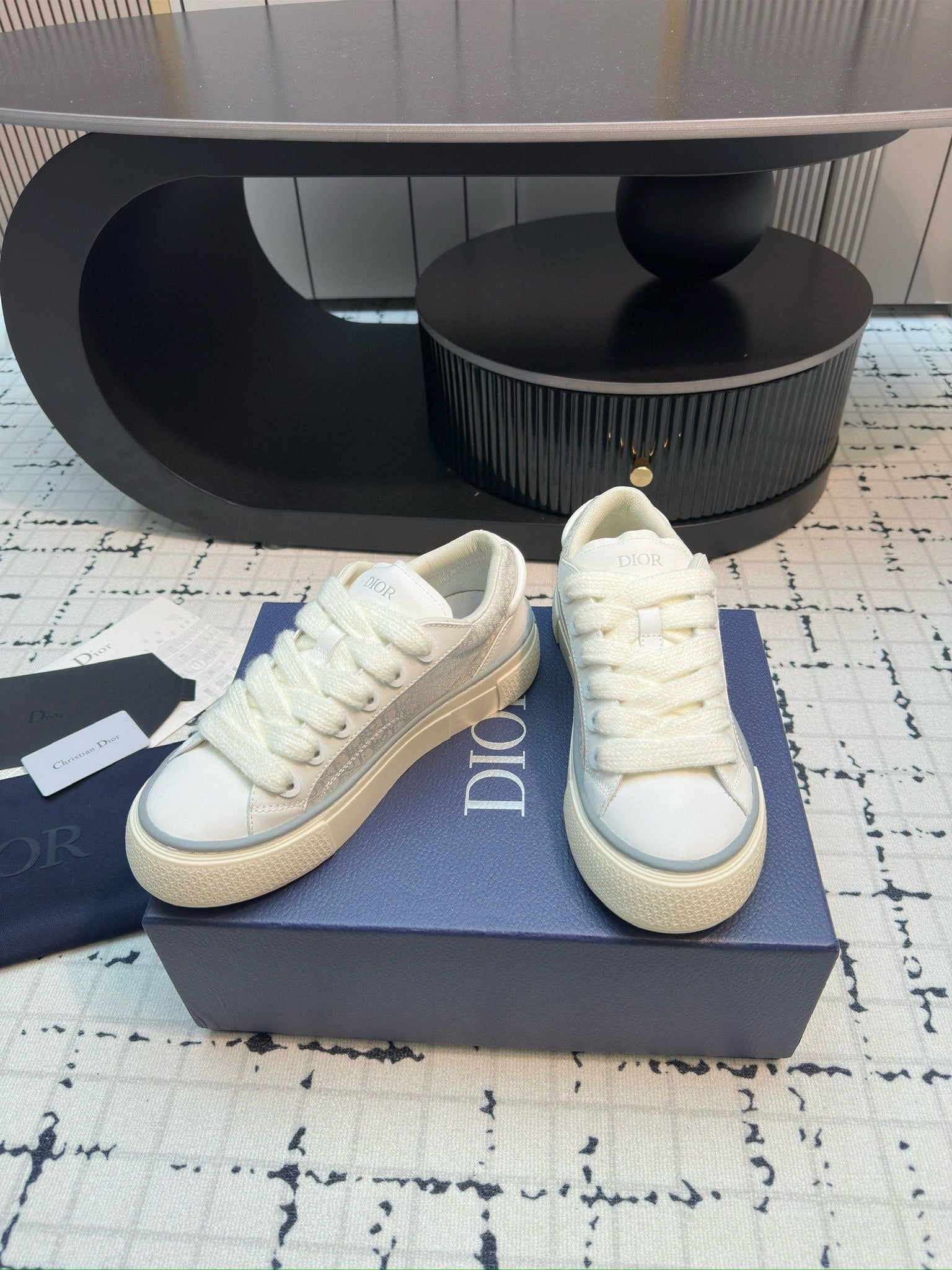 Dior unisex lace-up sneakers, white leather, three-quarter view with DIOR side