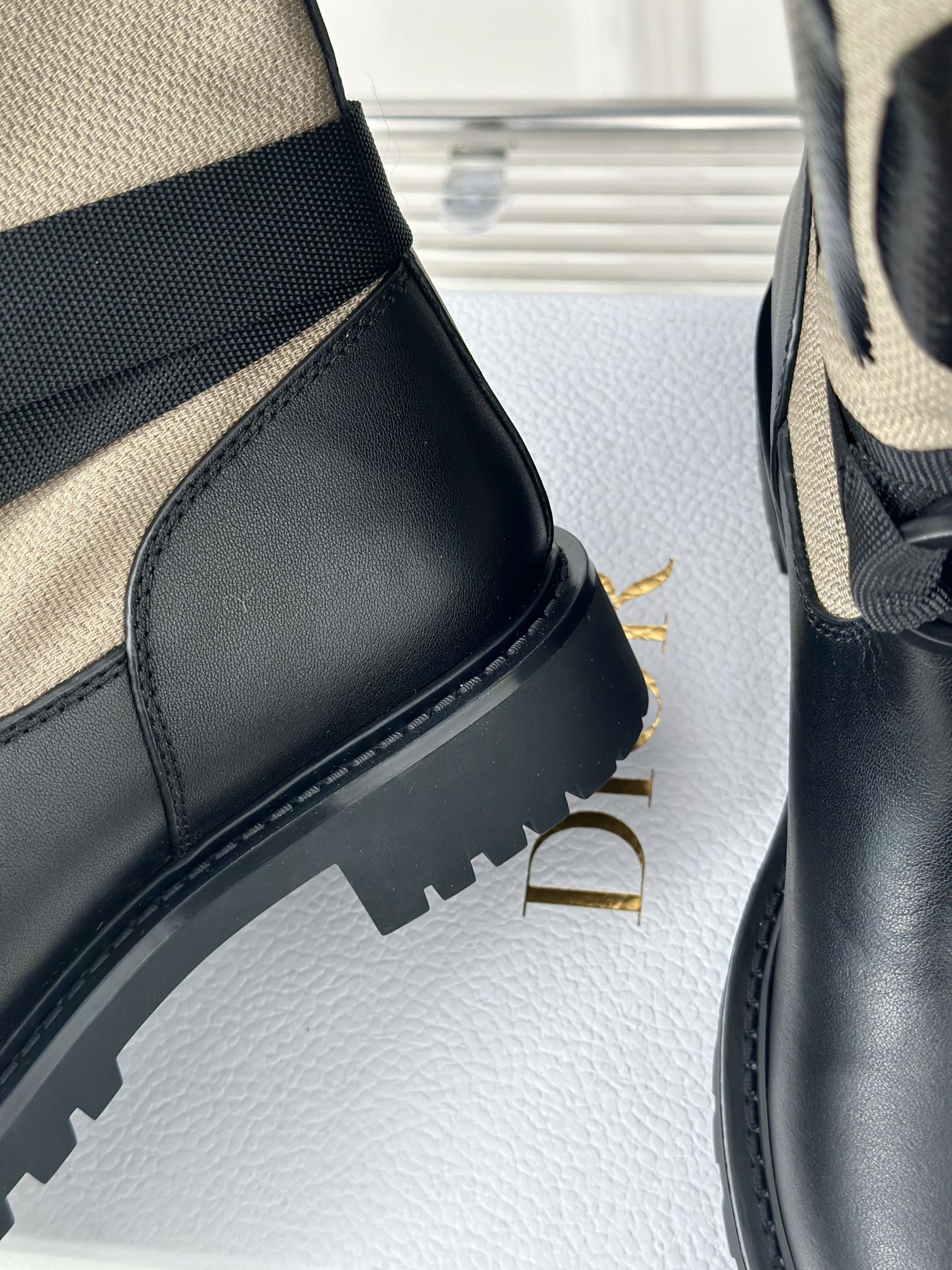Black leather boot with stitched seam detail and chunky tread sole