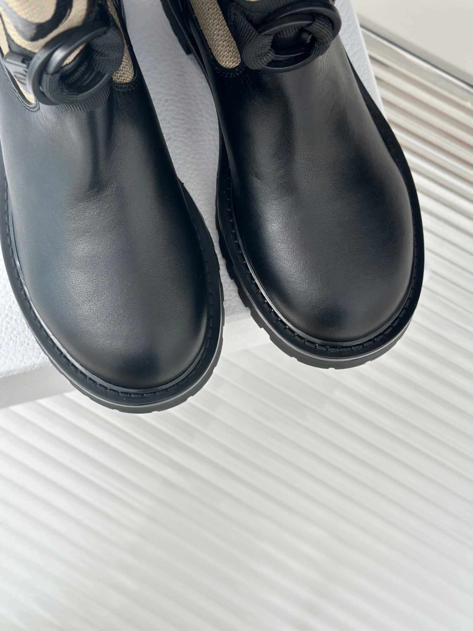 Pair of black leather ankle boots with thick rubber sole