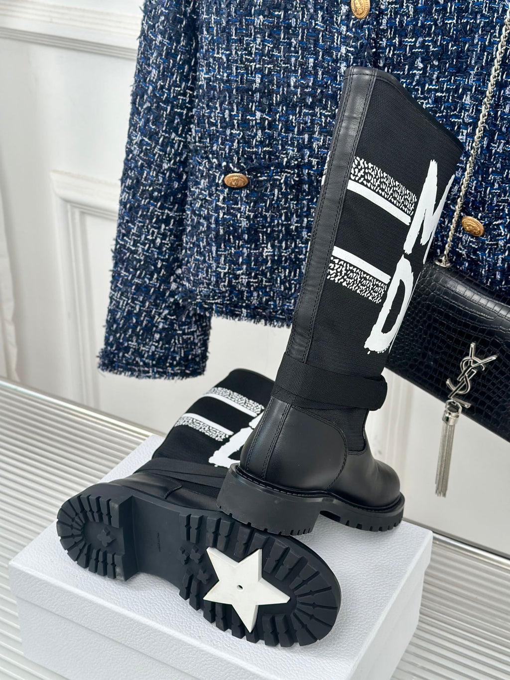 Black Dior logo boots with star-pattern outsole and thick platform sole