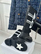 Black Dior logo boots with star-pattern outsole and thick platform sole