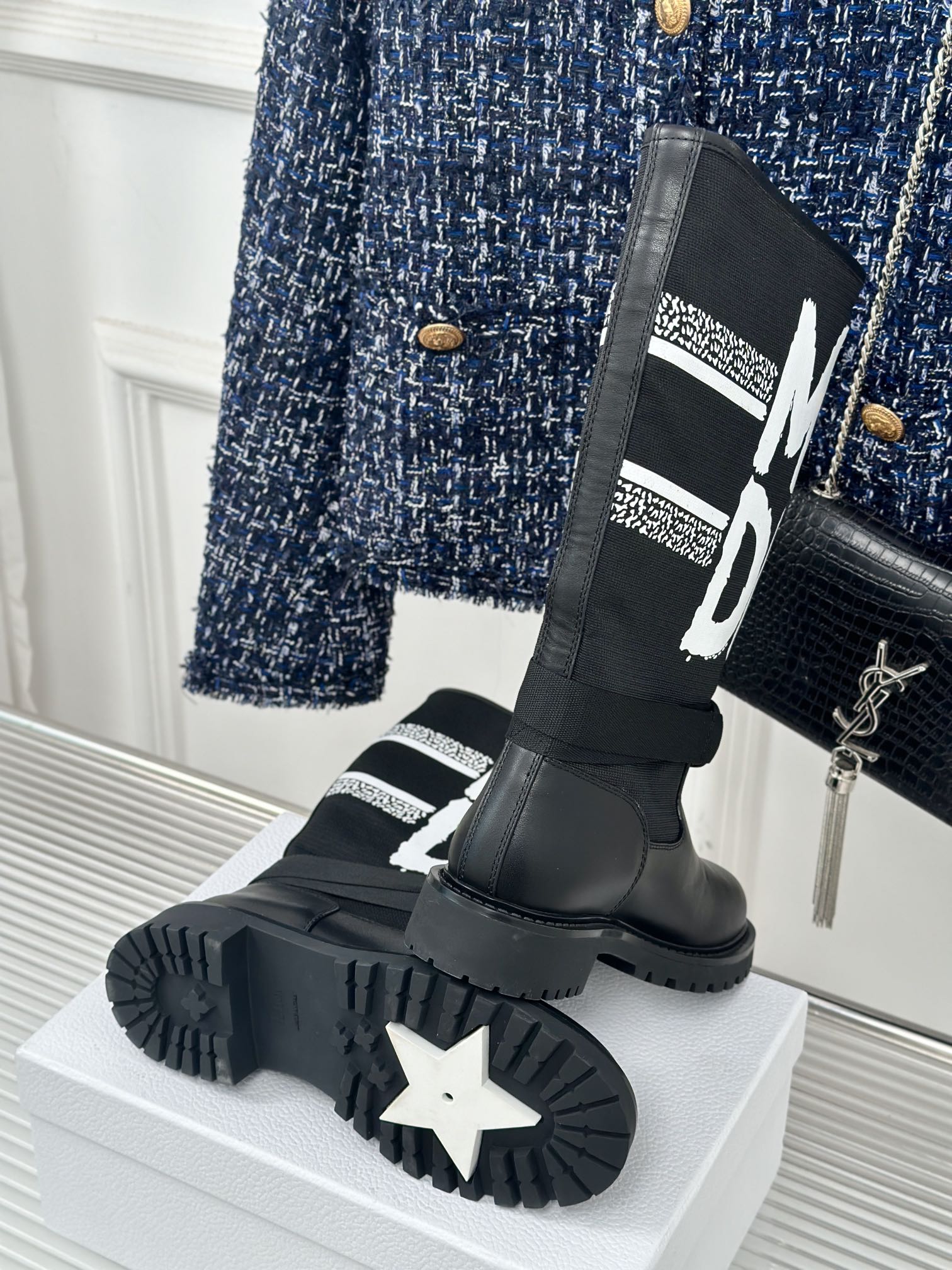 Black Dior logo boots with star-pattern outsole and thick platform sole