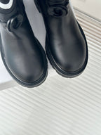 Black leather ankle boots close-up with round toe and lace strap