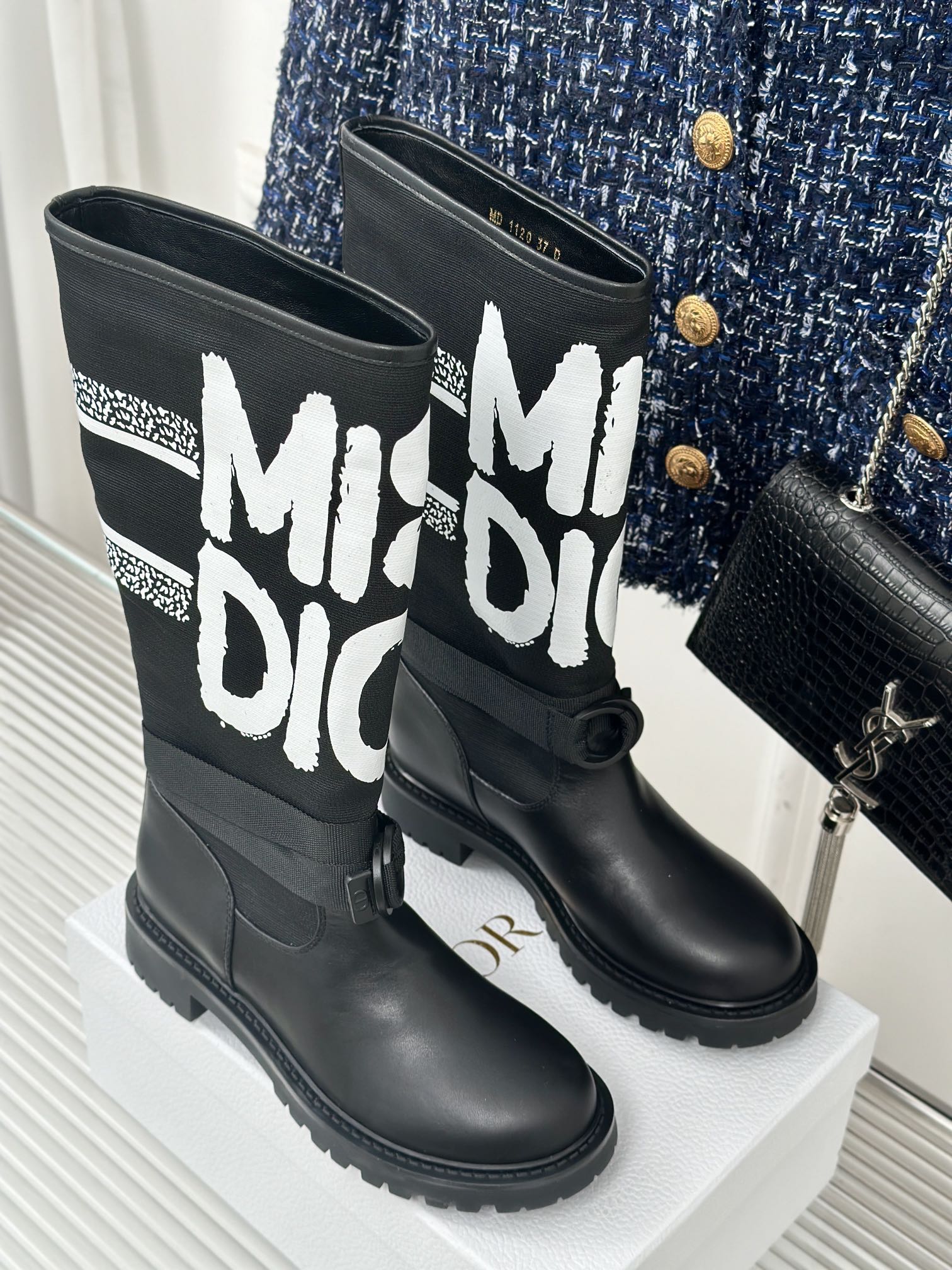 Black Dior logo mid-calf boots on display with chunky sole and lace-up