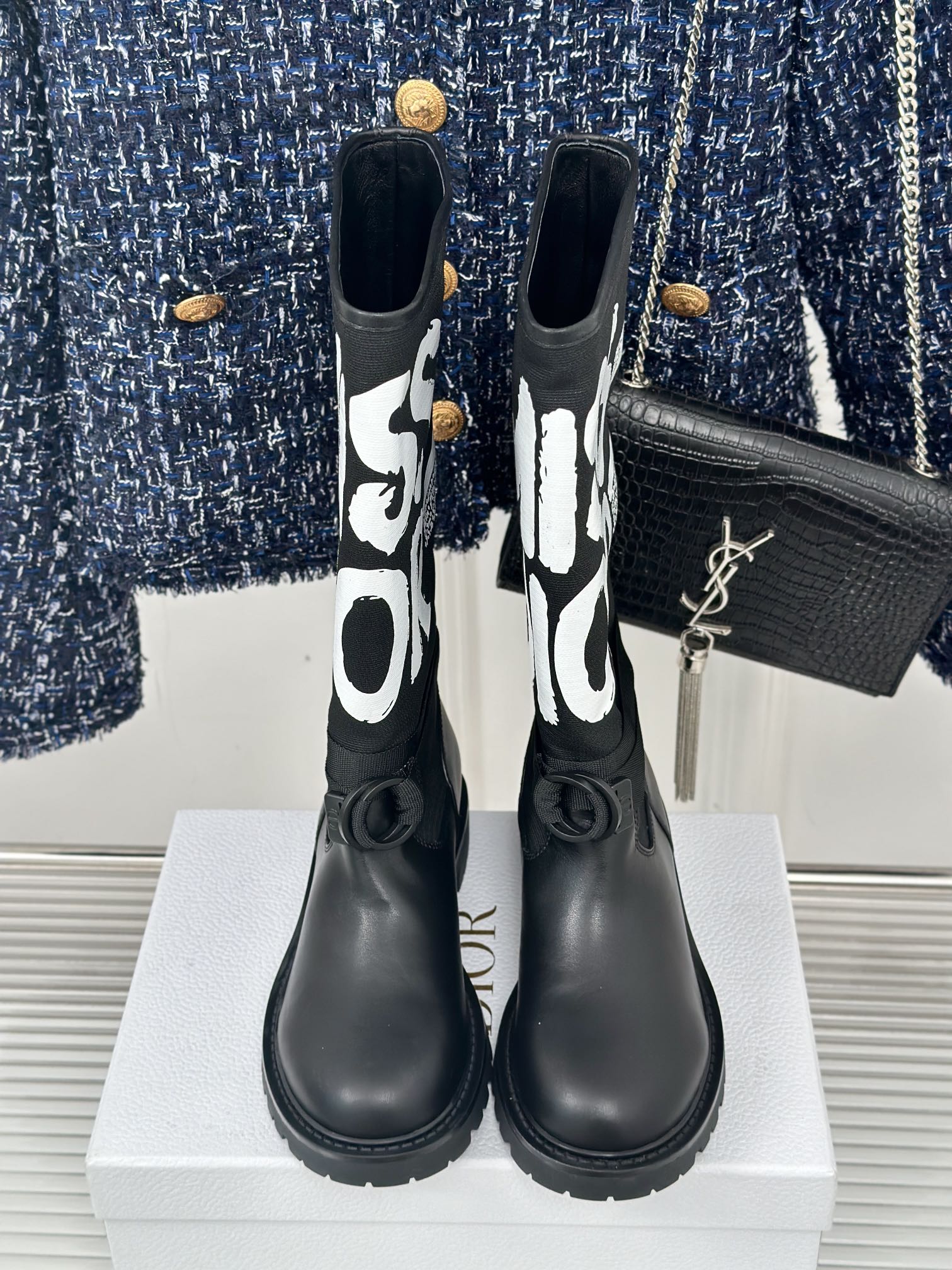 Black Dior logo mid-calf boots with gold YSL detail on the side and lace-up strap