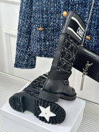 Black sole view of ankle boots with tread, paired with patterned fabric shaft